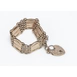 A 9ct gold gate link and padlock clasp bracelet, having textured patterned links and floral engraved