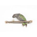 An early 20th Century platinum and gold diamond, ruby and demantoid garnet set parrot brooch, with