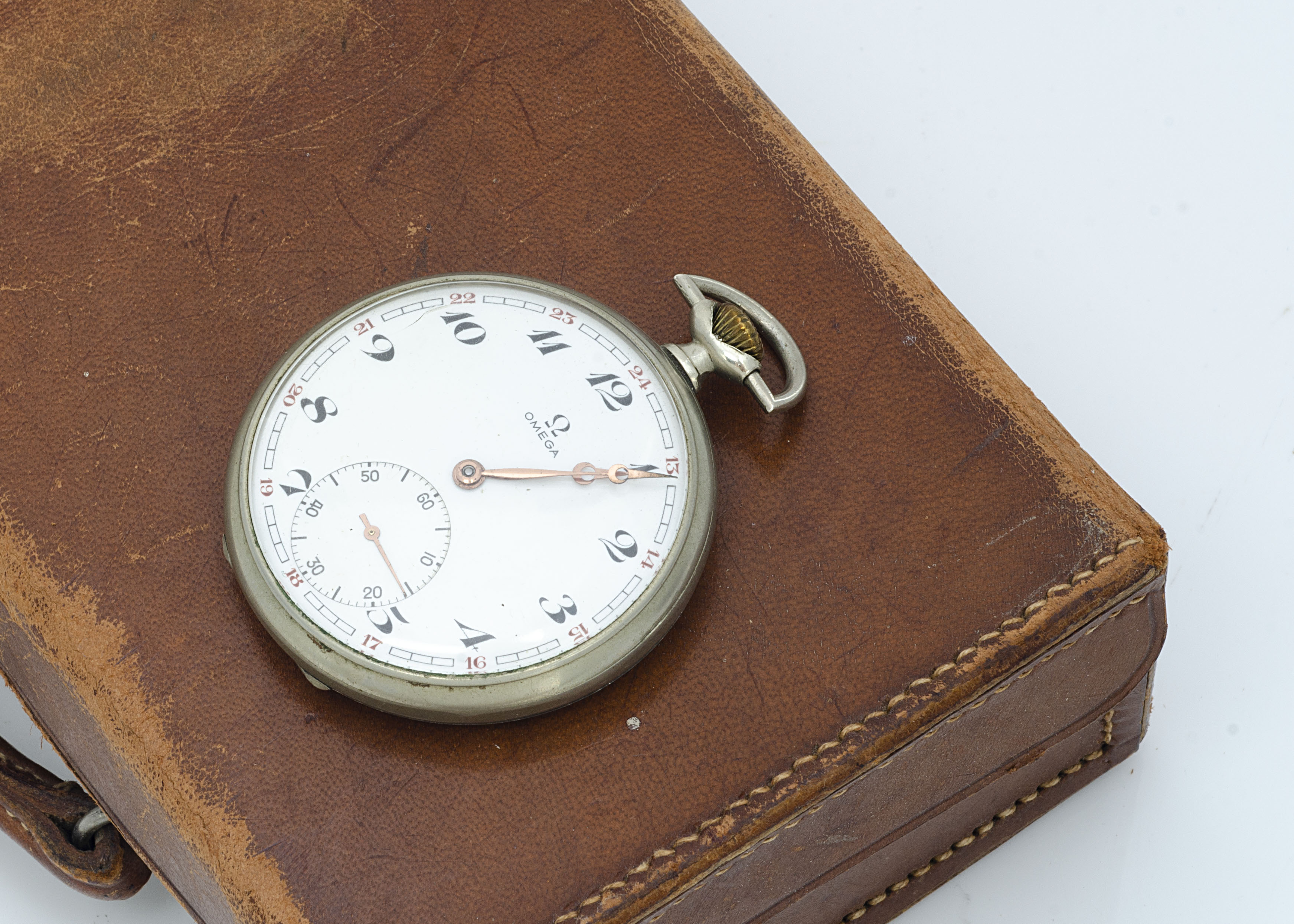 A 1940s Omega open faced pocket watch, 47mm, nickel plated case, white enamel dial having