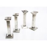 A set of four modern silver plated candlesticks, 23cm high of squared column form (4)