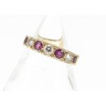 An 18ct gold ruby and diamond seven stone half hoop eternity ring, the brilliant cuts set with round