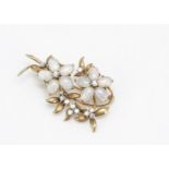 An 18ct gold opal and diamond floral spray brooch, the two opal flower heads centred with