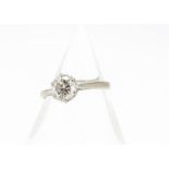 A brilliant cut diamond solitaire, in white metal marked 18ct, the six claw set diamond in