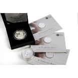 Five modern silver coins, including three 2013 Royal Mint A Timeless First £20 coins in packets, a