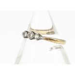 An 18ct gold three stone diamond ring, the brilliant cuts in claw setting all in 18ct yellow gold