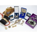 A quantity of costume jewellery, including an oval and enamel gold plated locket, an olive wood