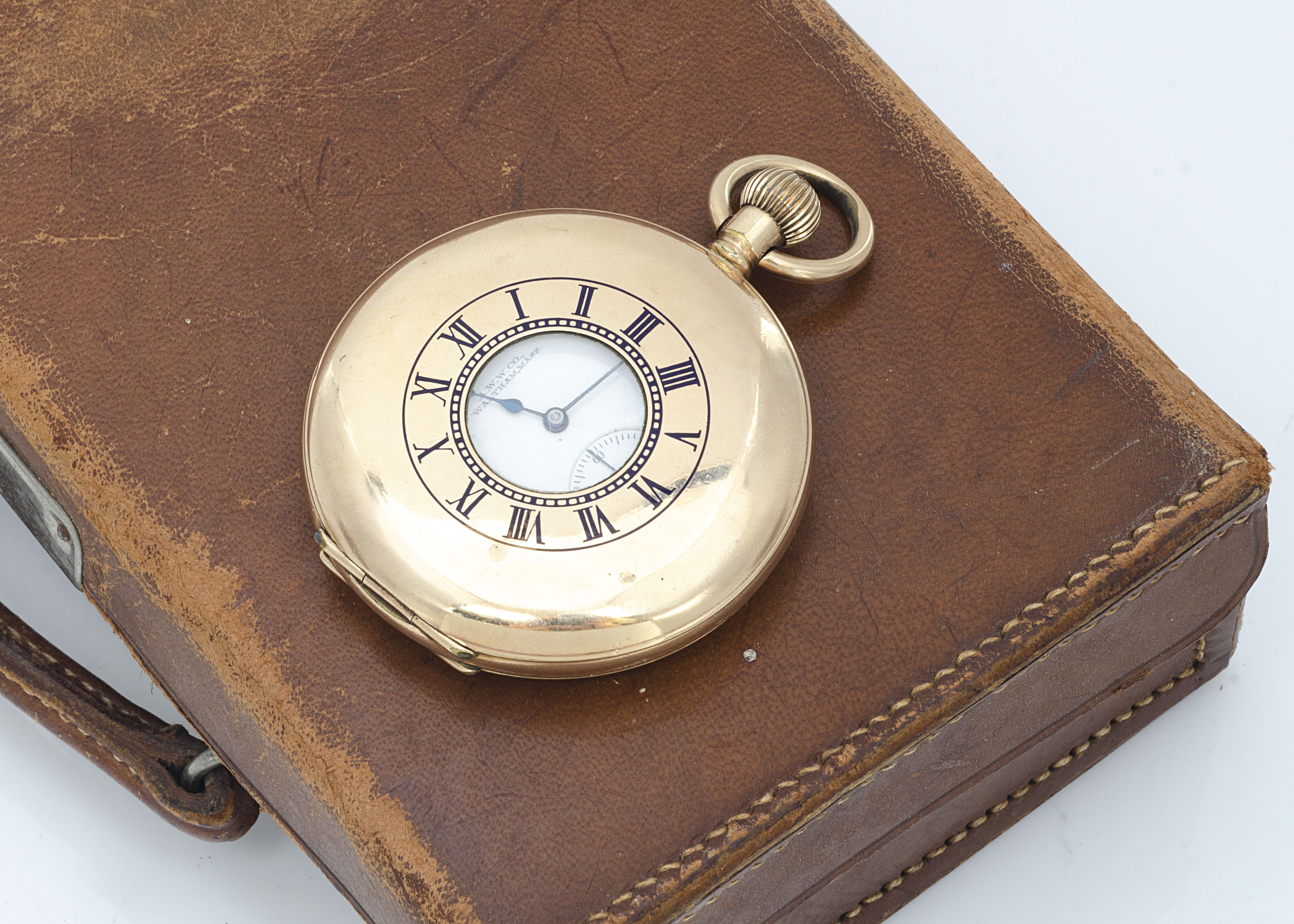 An early 20th century Waltham gold plated half hunter pocket watch, 50mm, with blue enamel Roman