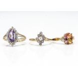 Three modern 9ct gold gem set dress rings, including tanzanite, mystic topaz and amethyst, all