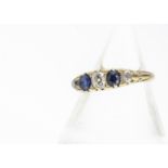 A five stone sapphire and diamond 18ct gold dress ring, with scroll gallery, ring size N, diamond