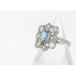 An Art Deco style aquamarine and diamond tablet ring, the central baguette cut stone surrounded by