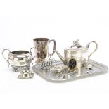 A 1930s silver tea strainer, together with a group of silver plated items and a black glass cameo