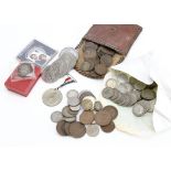 A collection of British and world coins, including several pre-1946 florins and shillings, along