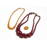 A cherry amber style double choker necklace, the graduated oval beads with base metal clasp, 23cm