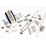 A collection of silver jewellery, including a teddy bear pendant, gem set pendants and rings,