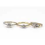 Three gem set dress rings, including an 18ct gold diamond solitaire and two cubic zirconia set dress