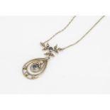 An Edwardian sapphire and seed pearl drop pendant, of oval pierced design, supported on a floral