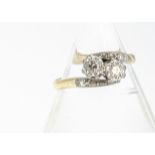 An 18ct gold diamond and platinum set crossover dress ring, diamond weight 0.20ct, ring size N, 3g