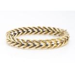 A 9ct gold plaited link bangle of oval shape, 5.8cm x 4.8cm, 20g