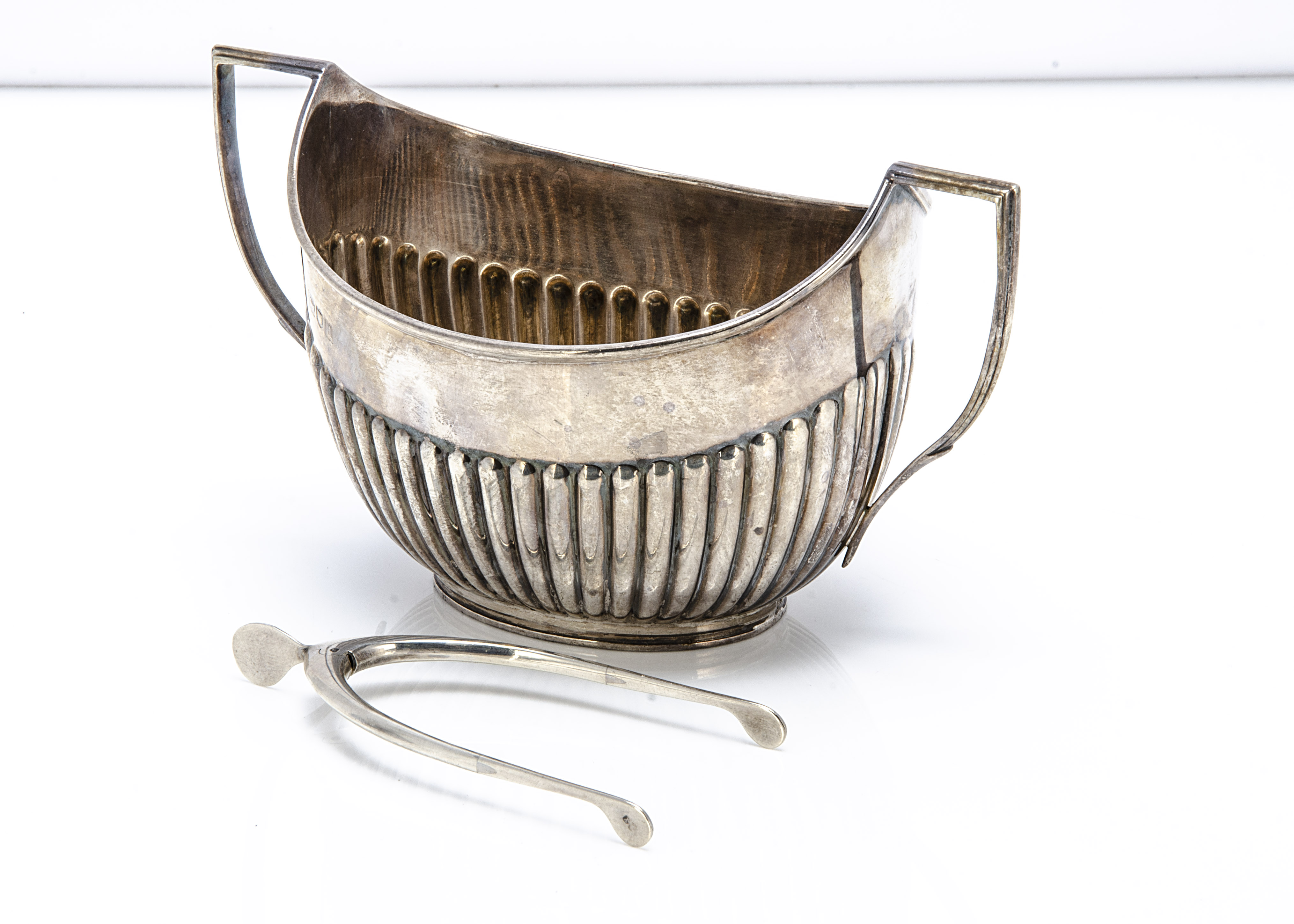 A late Victorian silver sugar basin by William Hutton & Sons, together with a pair of wishbone