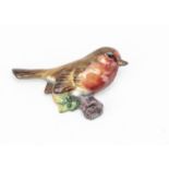 A Royal Worcester porcelain robin brooch, painted in colours with printed factory mark to reverse,