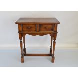 A 1900s oak side table, having fielded panelled drawer, shaped apron, turned leg, block feet. 64cm x