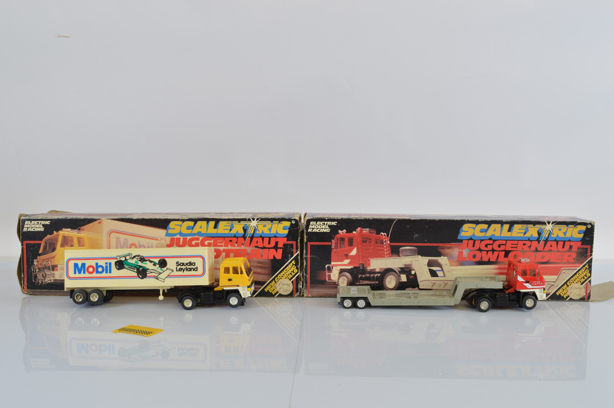 Two Scalextric Juggernaut slot car models, C301 Roadtrain and C302 Lowloader, both with boxes