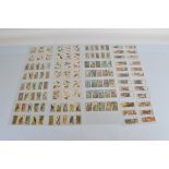 An album containing assorted cigarette and tea card sets, containing Players, Ogdens, Cavanders,