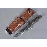 A Vietnam-era Camillus fighting knife, marked and dated Camillus U.S 2-1971, with 12.5cm long single