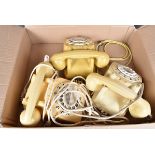 The vintage cream coloured Rotary telephones, all with receivers