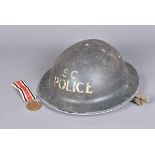 A WWII British Special Constable Police Brodie helmet, dated 1938, also stamped AK, complete with