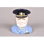A Carlton Ware Winston Churchill 'Prototype' character jug, with black cap with blue shirt, marked