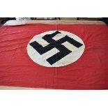 A large Third Reich building banner, the red banner with white circle and swastika to the centre,