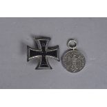 A WWI Iron Cross 1st Class, pin back, completely magnetic, stamped to the pin K.A.G, together with a