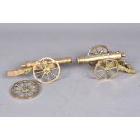 A pair of small brass Artillery Cannon models, one needing some attention to the axle, 18cm in