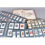 An assortment of cigareete card albums, comprisng various sets ans part sets
