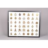An array of 35 British cap badges, to include Tank Corps, RAF, RFC, Reconnaissance Corps, Army