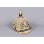 A WWI Bavarian Pickelhaube, the khaki coloured helmet with applied brass spike to the top, and