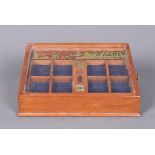 A vintage Thorens Tobacconist's Counter display case, with angled glazed top, with sidewards slide