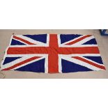 A British Royal Navy ship's Union flag, with brass fixtures to the side, with original rope and