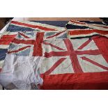 Three sizeable Union Flags, approx. 270cm x 130cm and smaller, one marked in hand written ink '