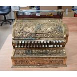 A heavily embossed decorative brass National Cash Register, 226148, Dayton Ohio USA, the single