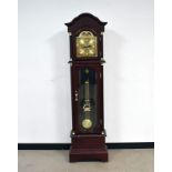 A modern longcase clock gun safe, with brass dial with moon phase style design, battery operated