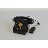 A black Bakelite rotary dial telephone, 706 model, circa 1961 with Stafford paper label
