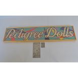 A vintage framed scarce 'Pedigree Dolls' retailers paper sign, the blue background of which
