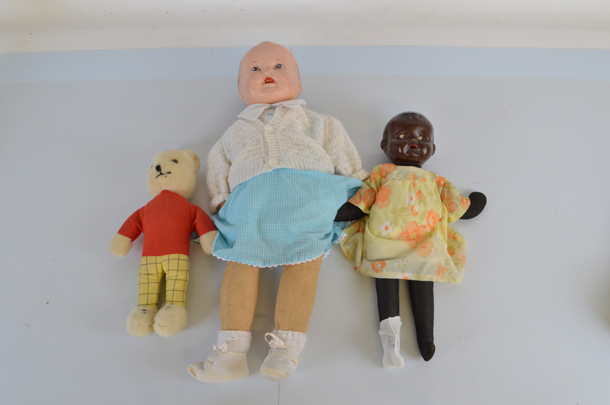 Two composite dolls, the largest with speaker set in back 70cm long together with a Rupert Bear doll