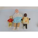 Two composite dolls, the largest with speaker set in back 70cm long together with a Rupert Bear doll