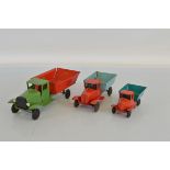 Three different unboxed vintage Tri-ang steel bodied variants of the Tipper Lorry model, all with