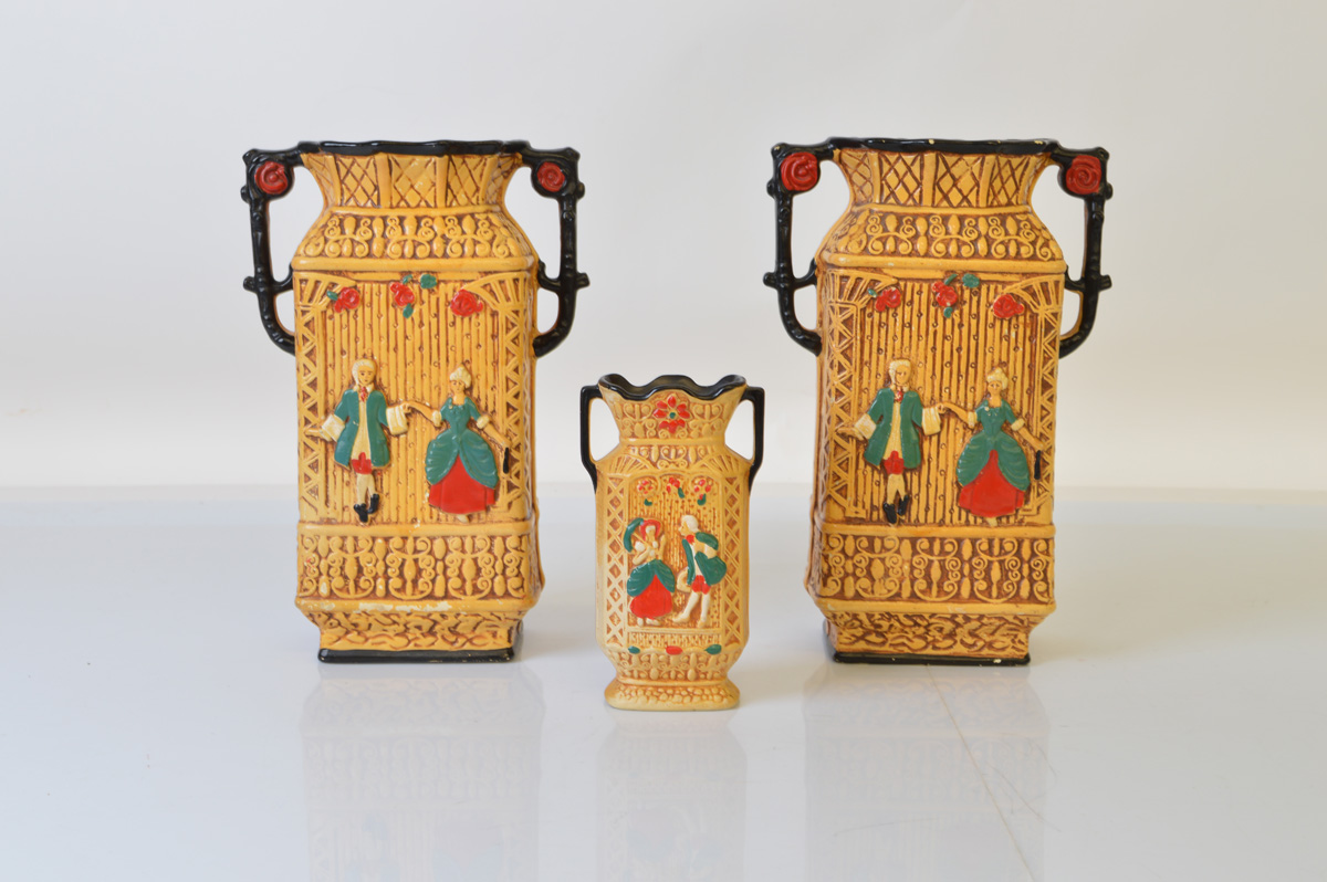 A pair of Art Deco twin handled plaster vases, 25cm tall together with a smaller example 14.5cm tall