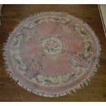 A set of five Chinese woollen rugs, differing shapes and sizes, each with floral medallion and