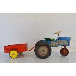 A Tri-ang TM2016 three wheel 'Little Farmer' Pedal Tractor in blue, with blown plastic body and